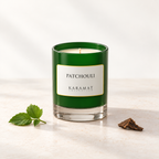 Bougie parfumée Patchouli, pot vert avec quelques feuilles et une touche de bois.